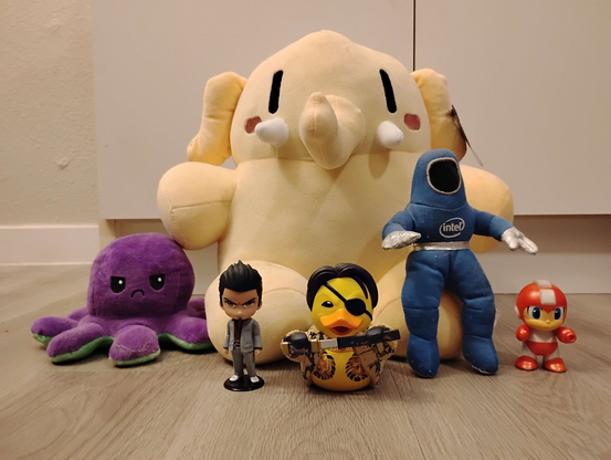 A misfit of toys which include a Plushtodon, Octopus, Kiryu from Yakuza, Duck Majima from Yakuza, a Clean Suit Intel Guy, and Megaman.